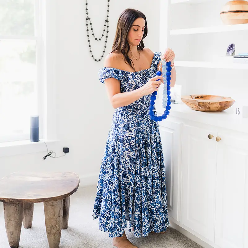 dikla in a blue dress organizing a home with interior design