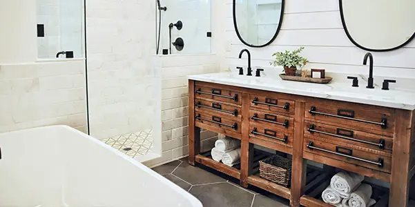 elegant bathroom with wood counter and clawfoot tub with walk in shower