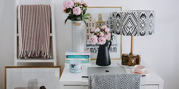 an organized living room with a glass coffee table