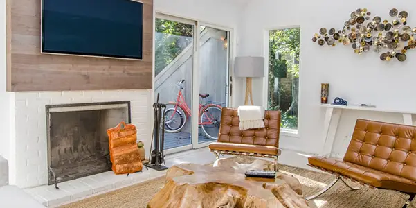 an organized living room with a glass coffee table