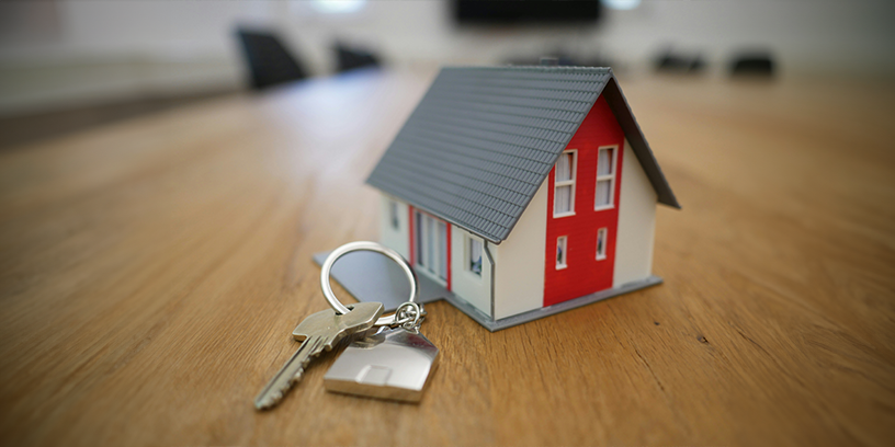 small house sitting on a table with keys