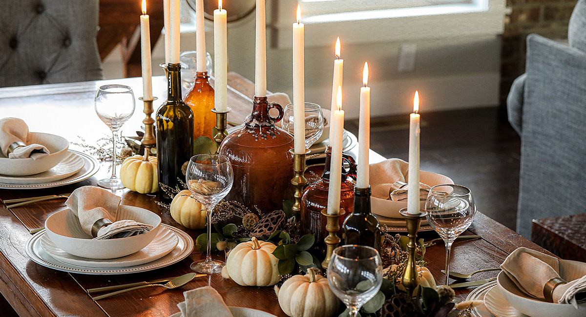 candles on a table with thanksgiving decor