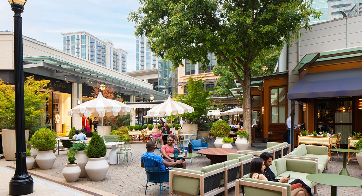 Buckhead Village District image with people sitting under umbrellas